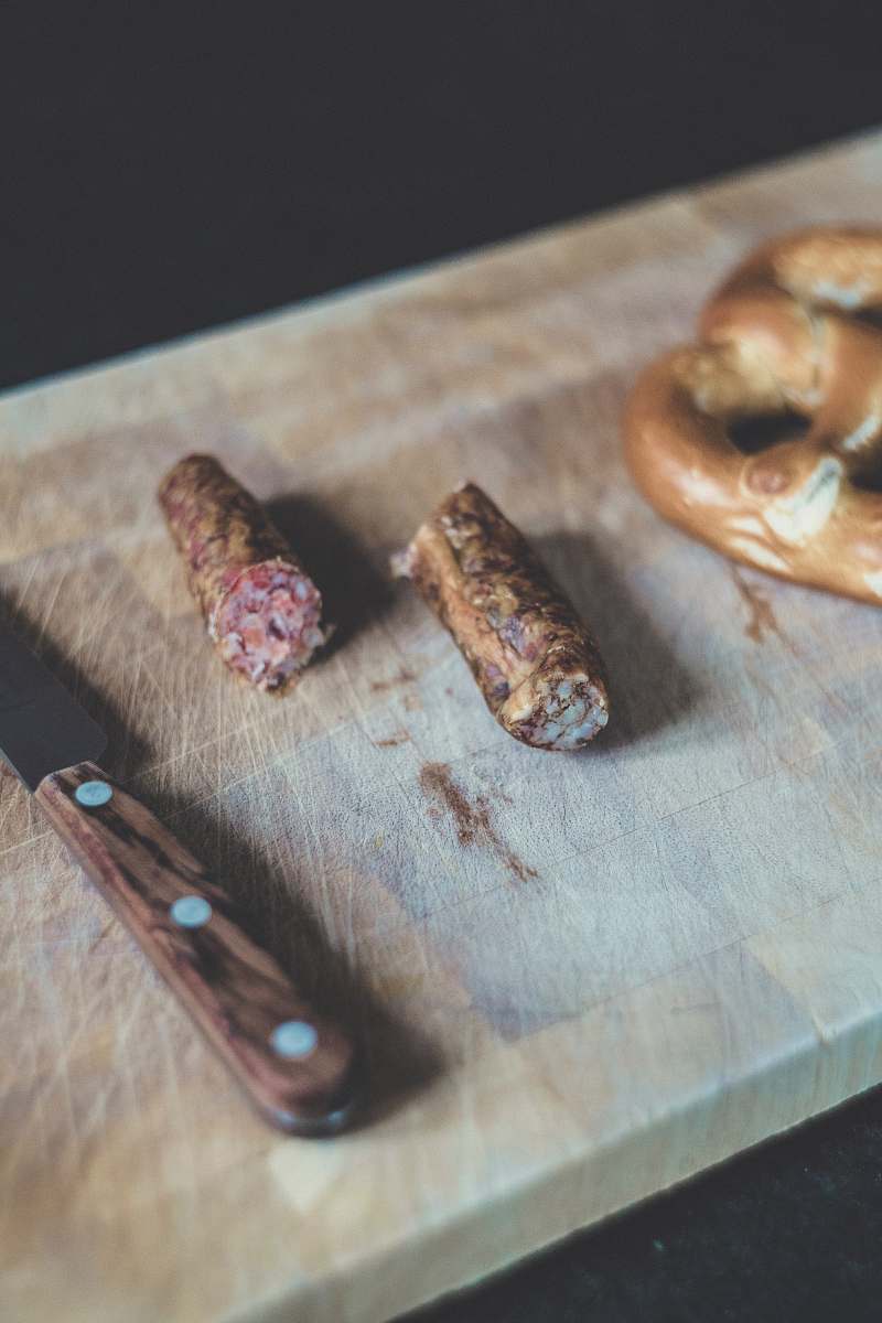 furniture sliced sausage beside brown handle knife table